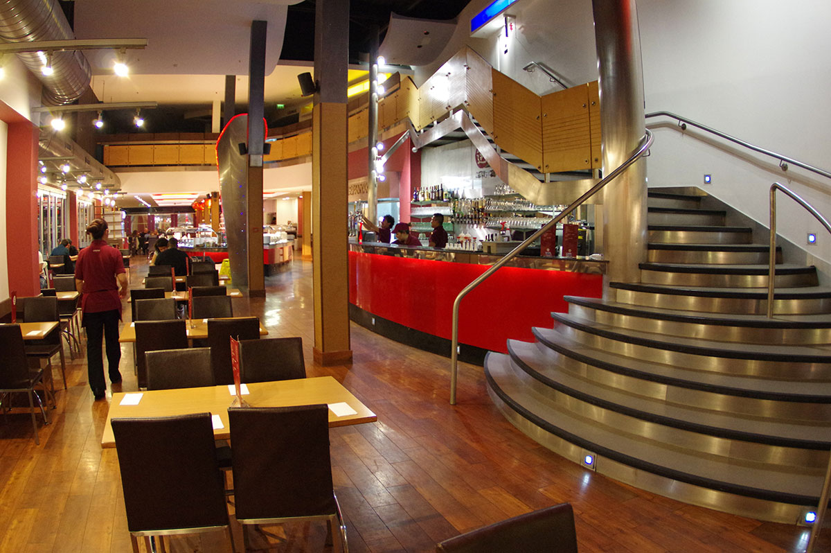 View of seating and staircase inside Aroma restaurant